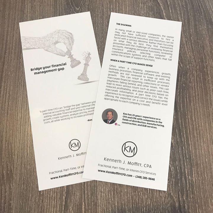 Two brochures with a hand holding a chess piece and a picture of a man
