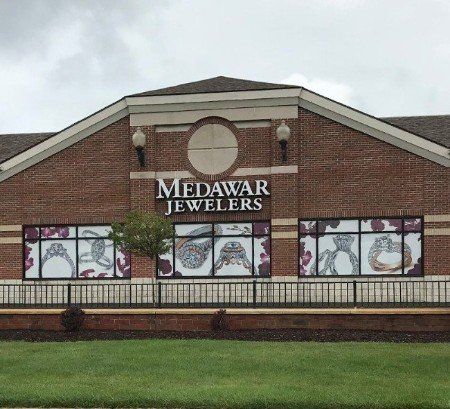 A brick building with a sign that says medawar jewelers