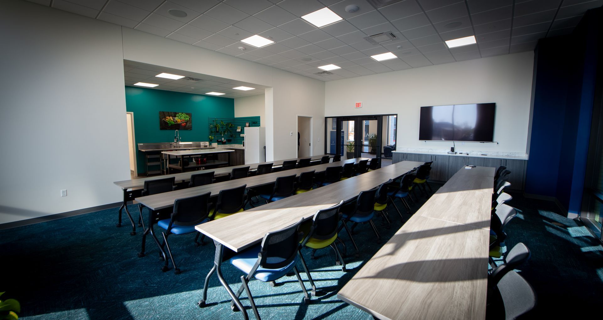 There are a lot of tables and chairs in this room.