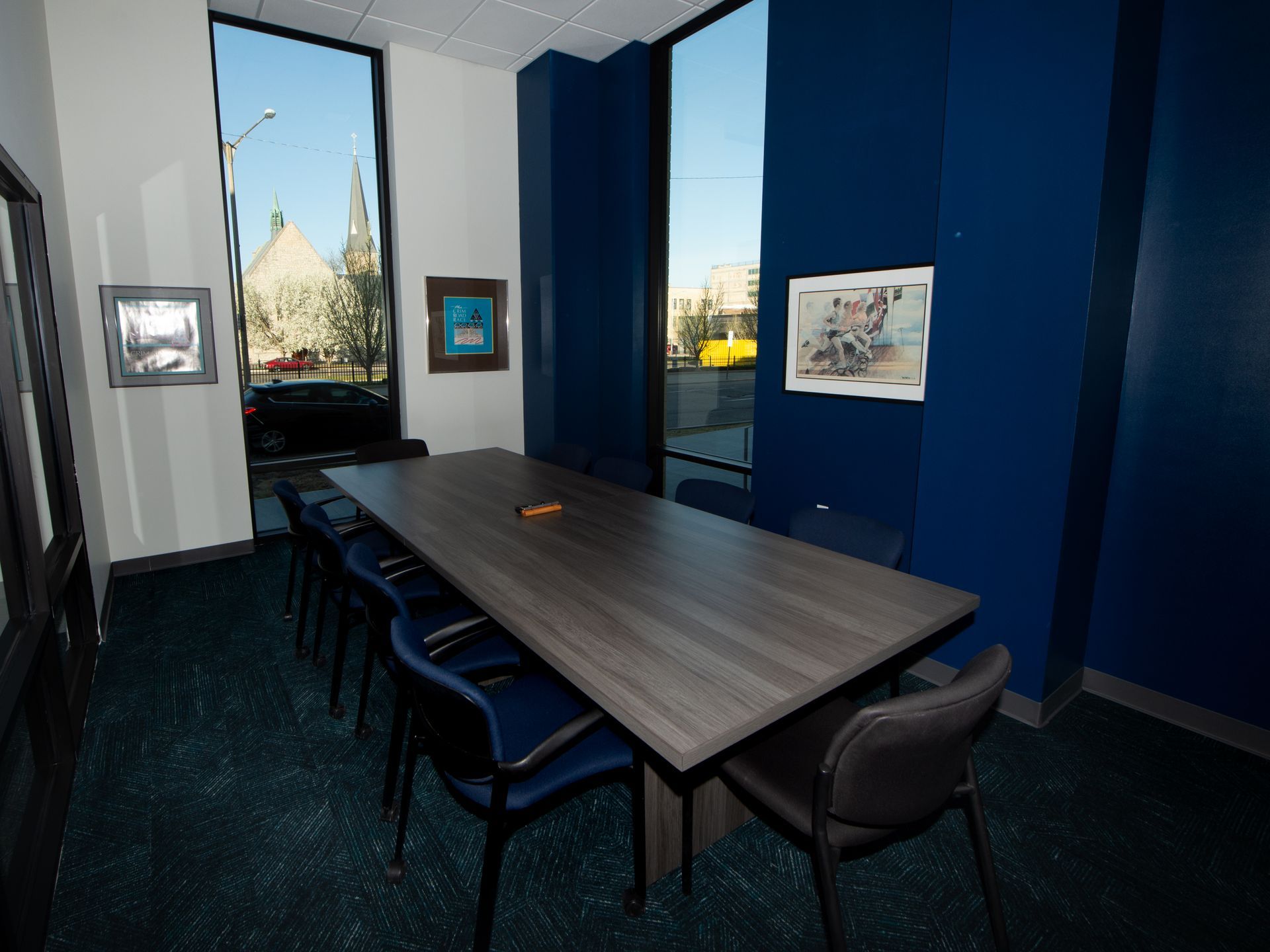 A conference room with a long table and chairs