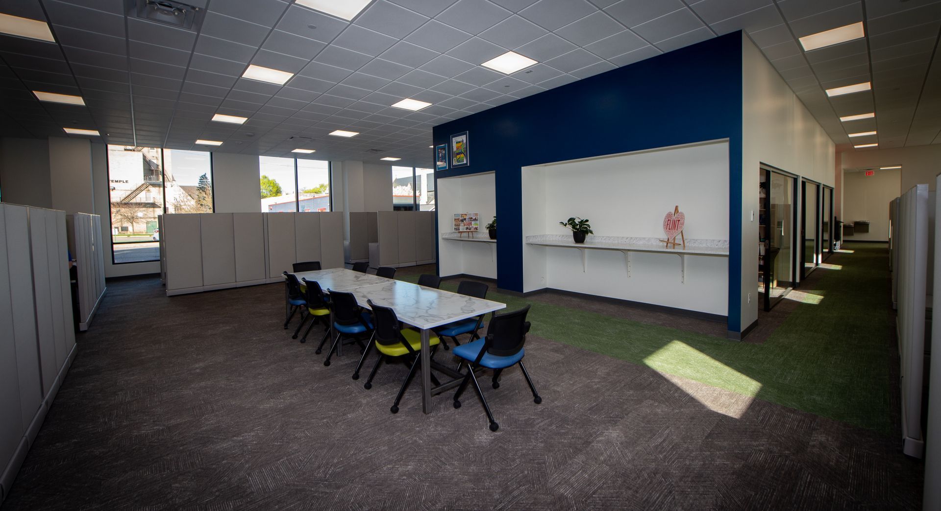 A large room with a table and chairs in it.