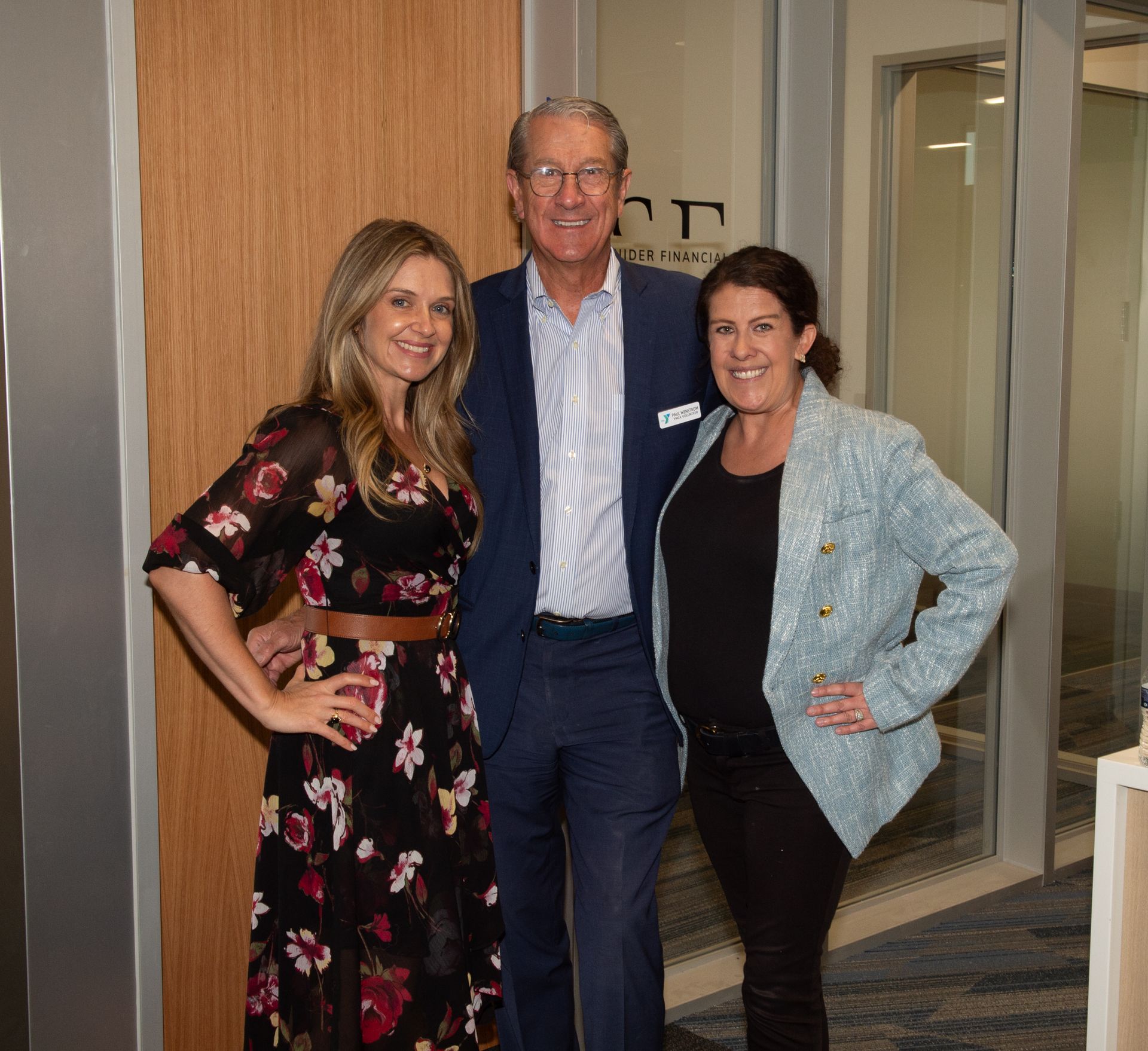 A man and two women are posing for a picture together