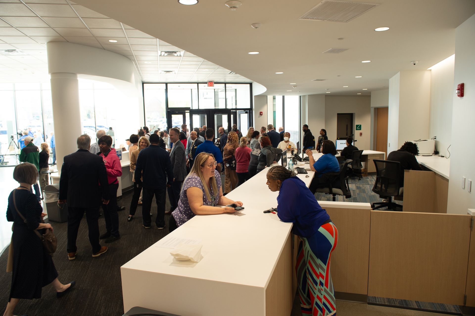 A group of people are standing around a counter in a lobby.
