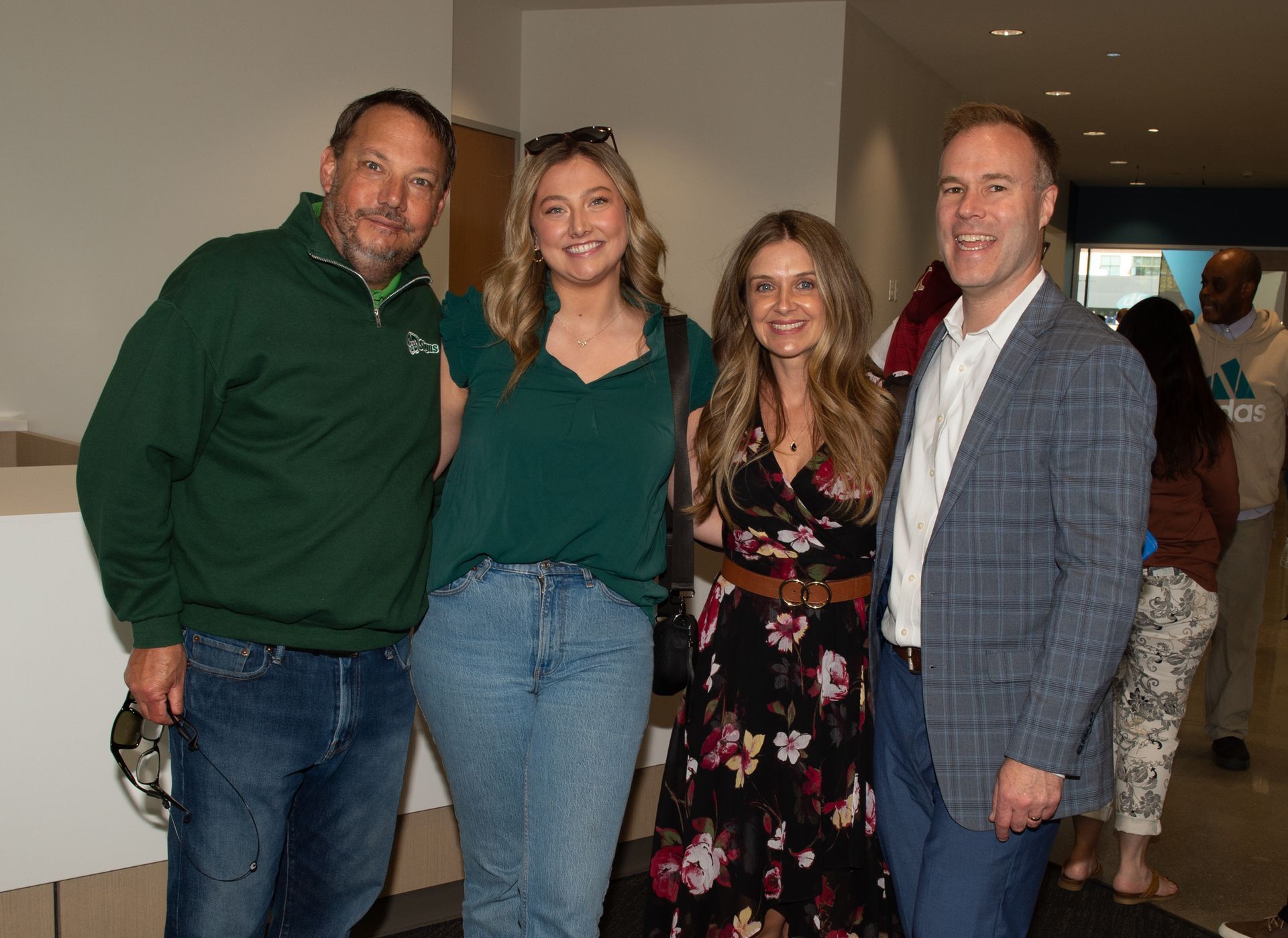 A group of people are posing for a picture together in a room.