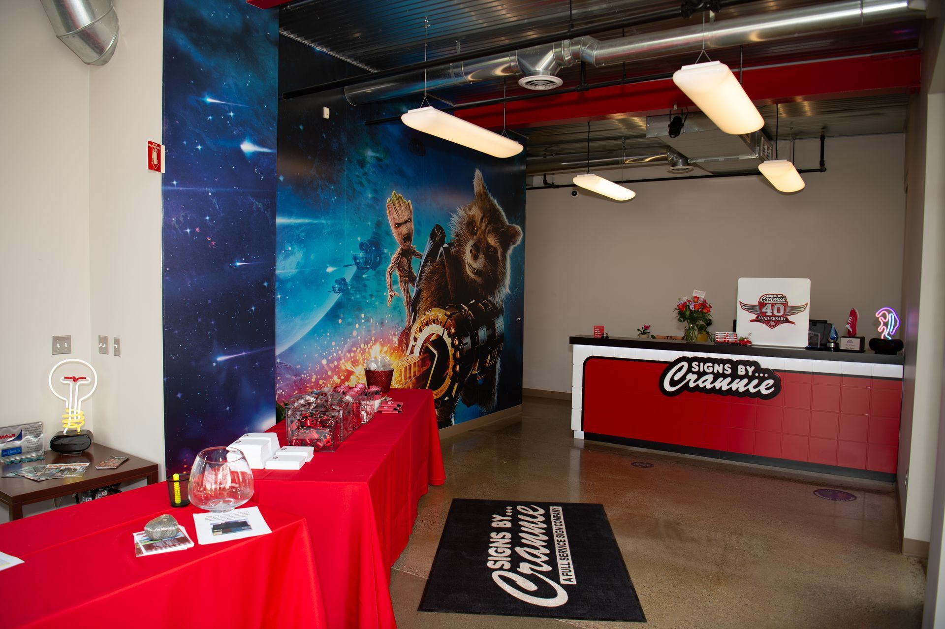 A room with red tables and a sign that says guardians of the galaxy
