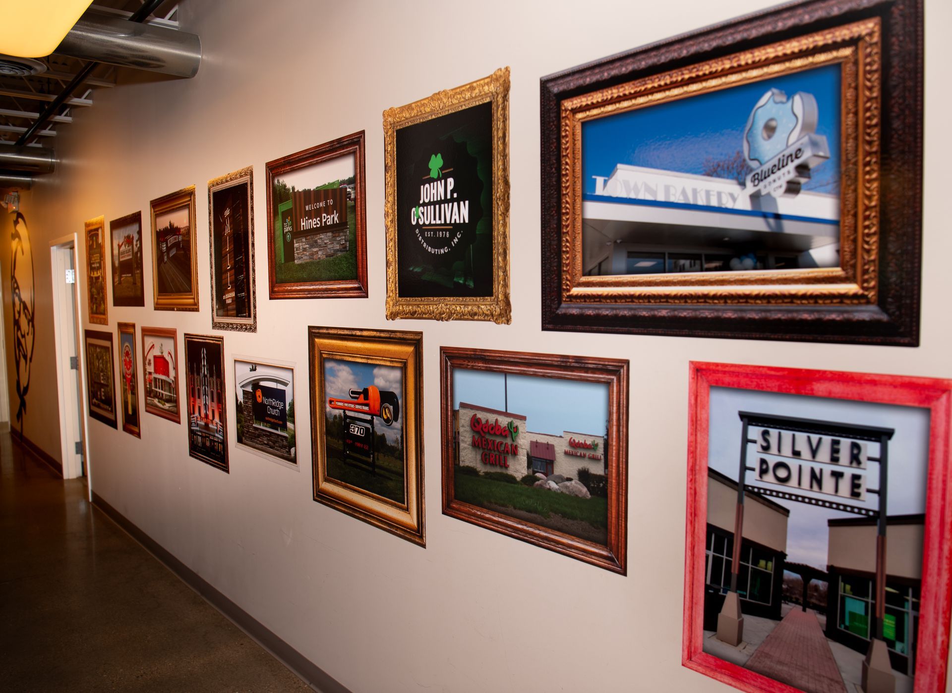 A row of framed pictures on a wall including one that says silver pointe