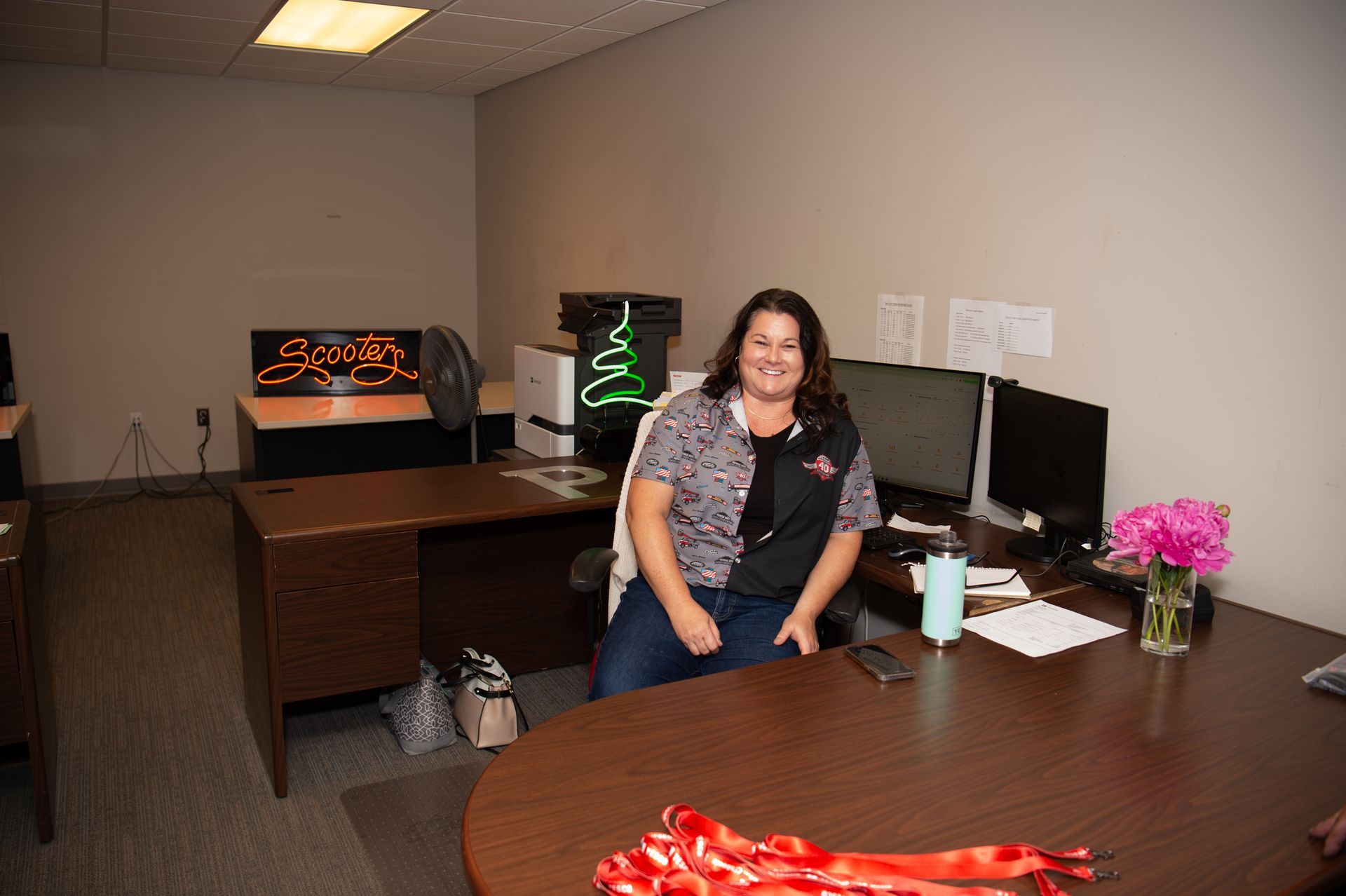A woman is sitting at a desk in an office.