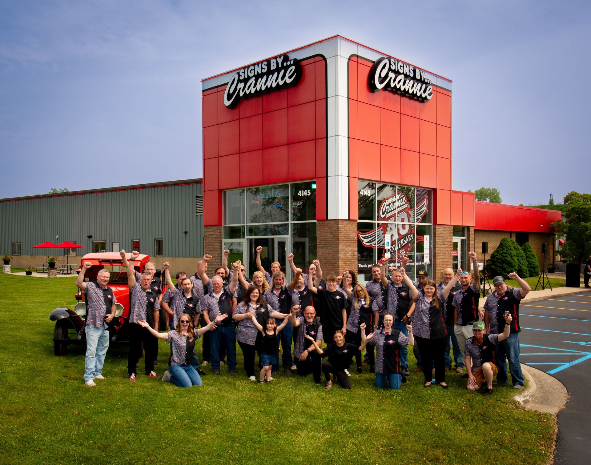A group of people standing in front of a building that says cranes