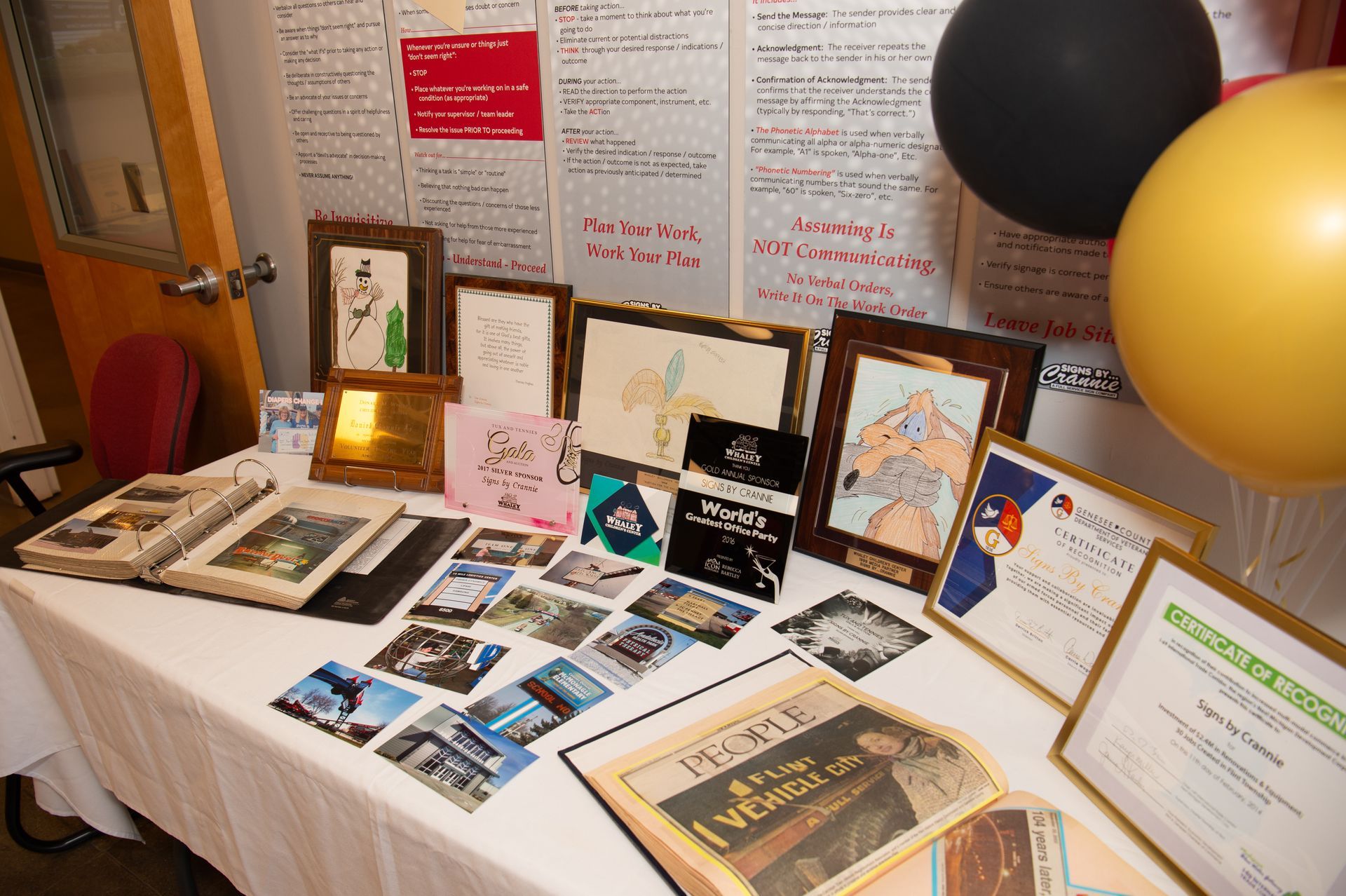 A table with a bunch of papers and pictures on it