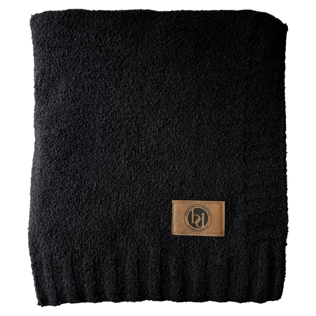 A black scarf with a leather tag on it