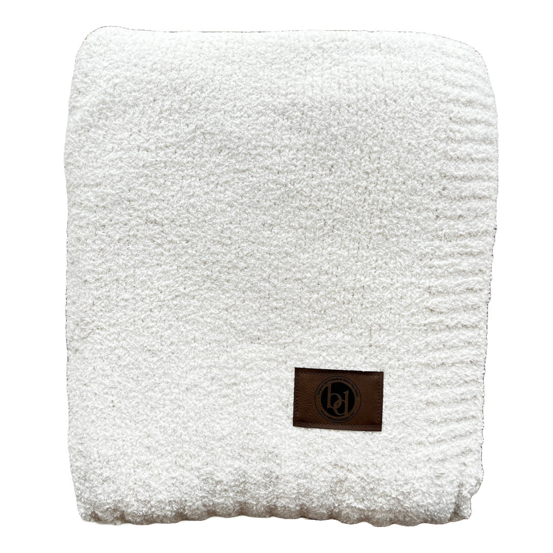 A white towel with a brown label on it on a white background.