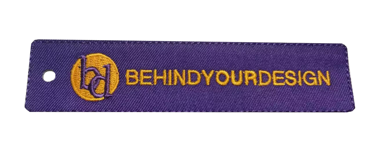 A purple tag with the words behind your design on it