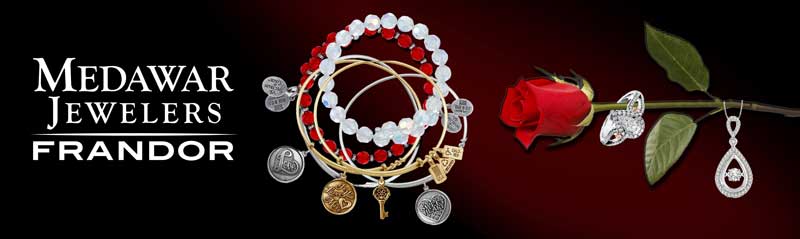 A red rose is sitting next to a bunch of jewelry on a red background.