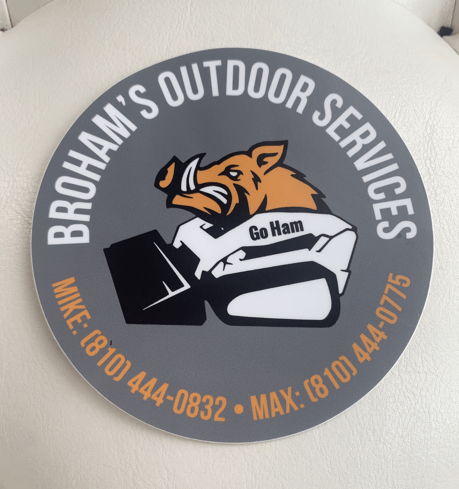 A logo for broham 's outdoor services with a picture of a boar