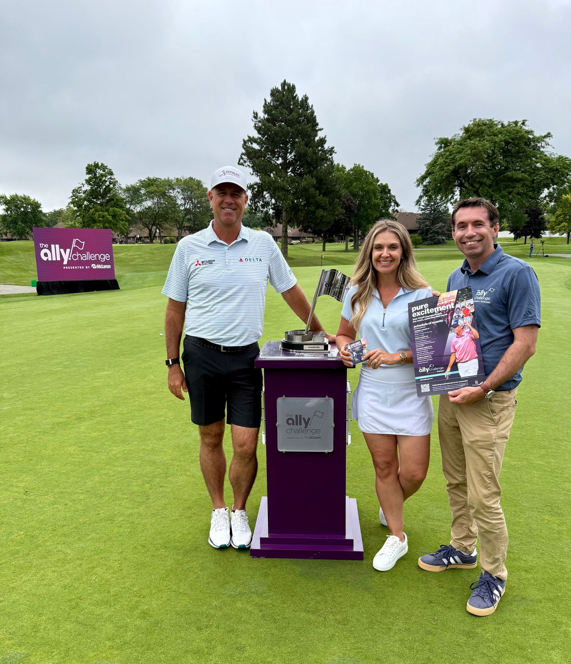 Two people standing next to a cardboard cutout of thomas rhett