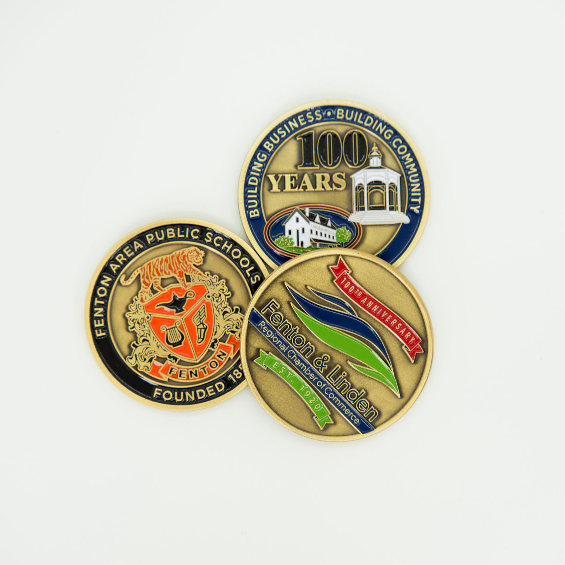 Three coins with one that says 100 years on it