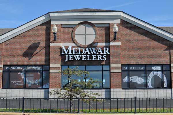 A brick building with a sign that says medawar jewelers