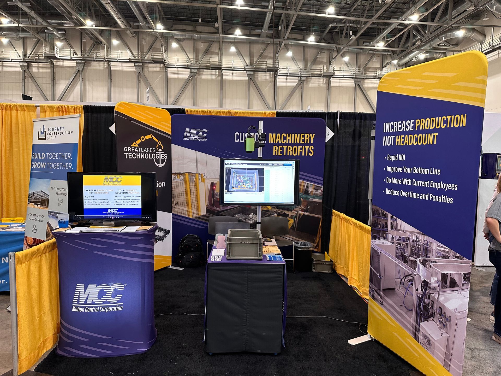 A booth with a monitor and a sign that says mcl