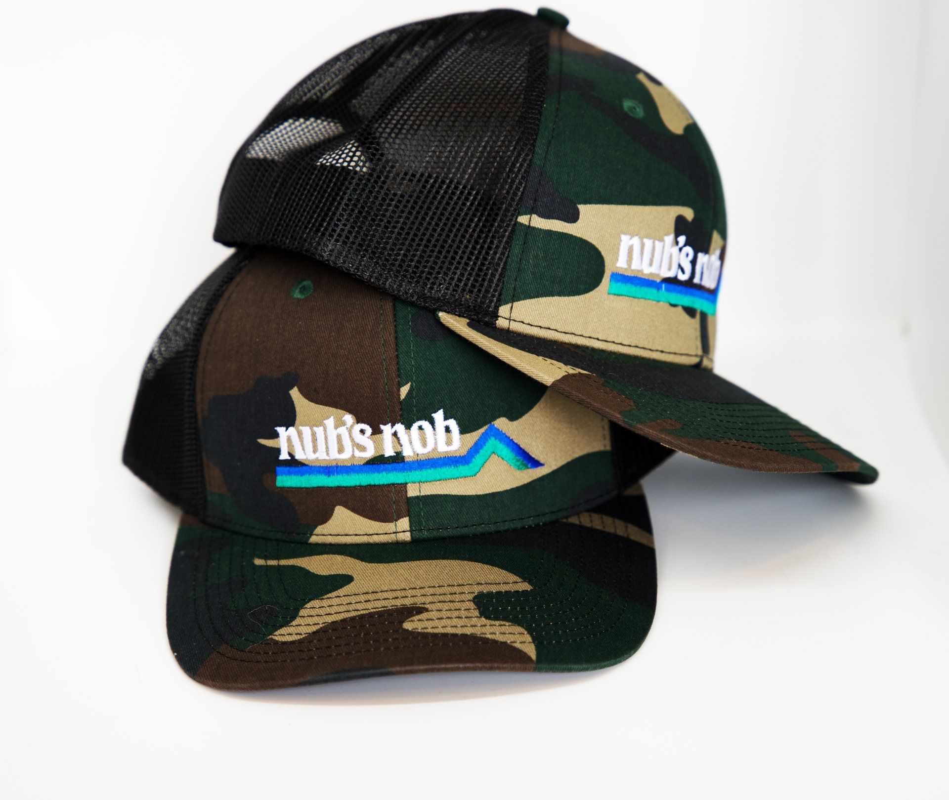 A camouflage hat with the word nubs on it