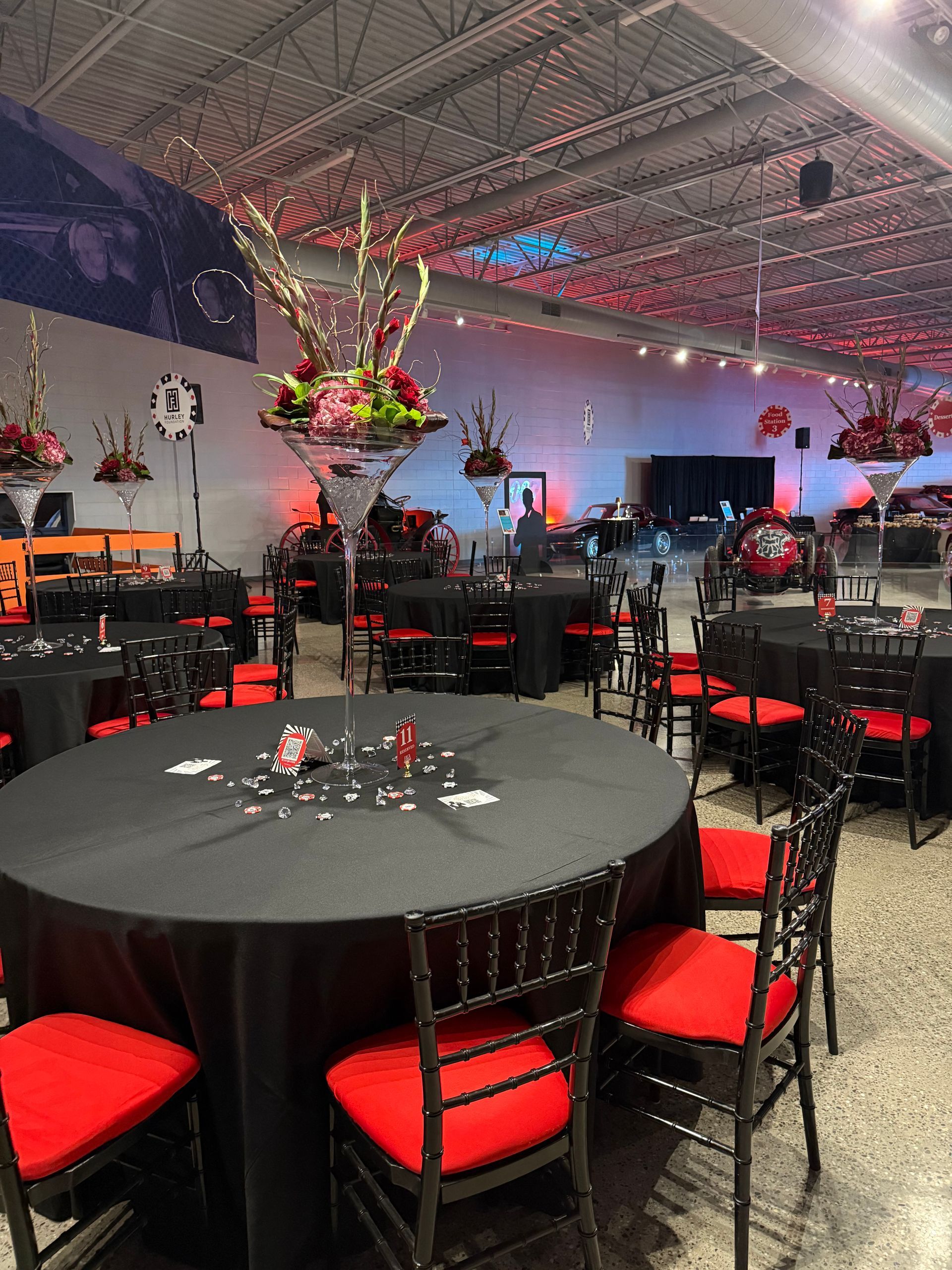 A large room with tables and chairs set up for a party