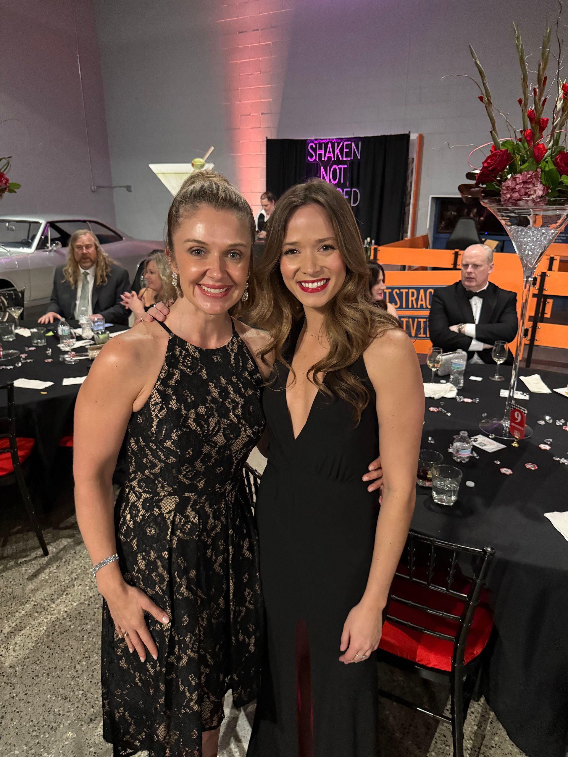 Two women are posing for a picture at a party