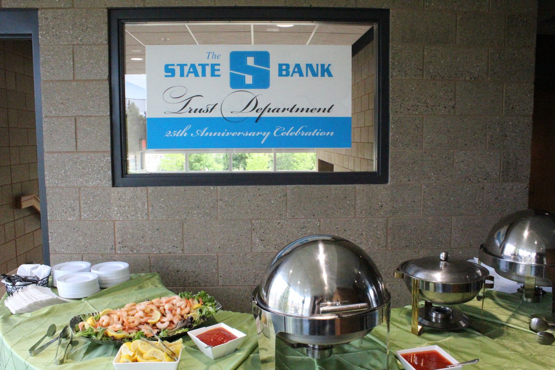 A buffet table in front of a sign that says state bank