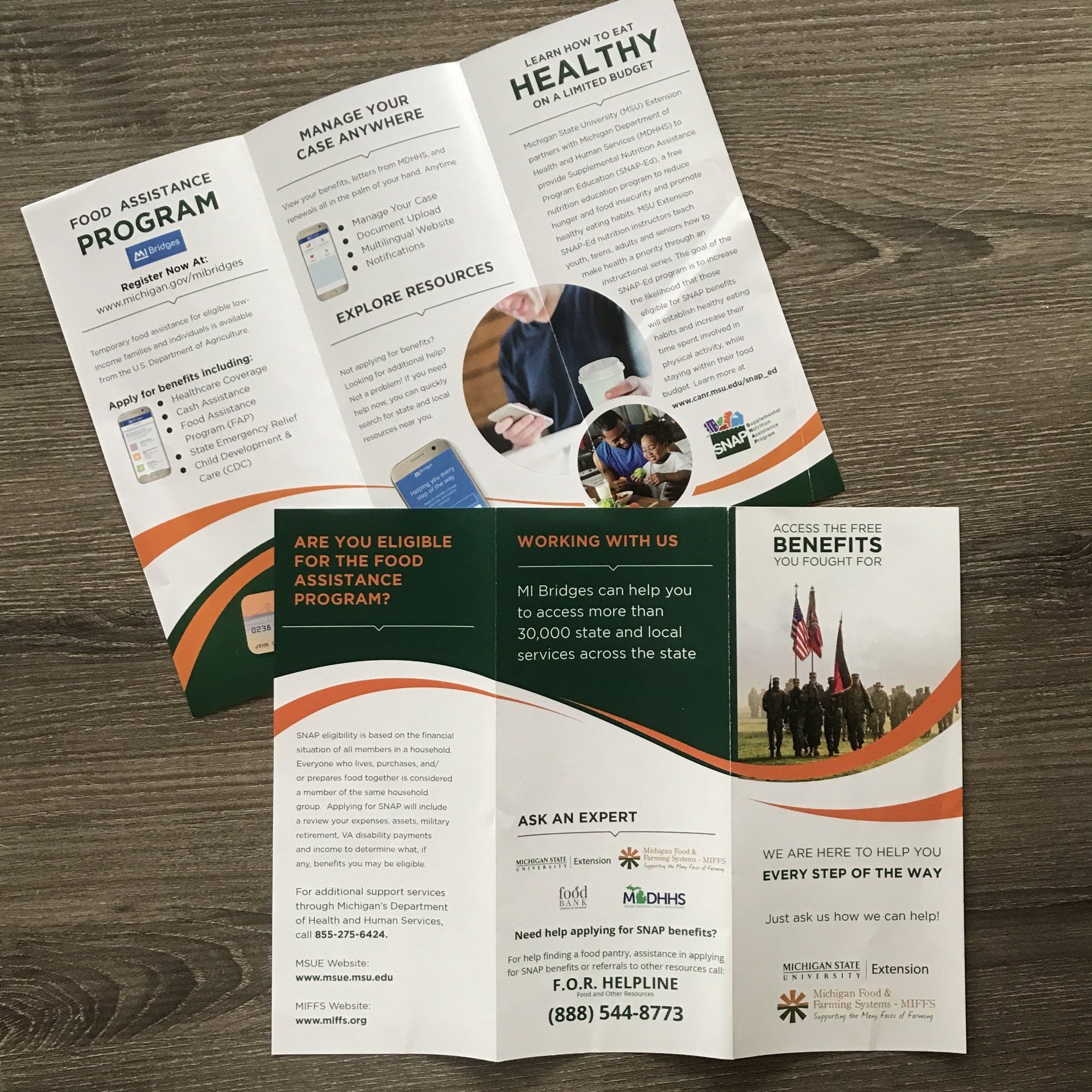 A brochure for a healthy living program is sitting on a wooden table.