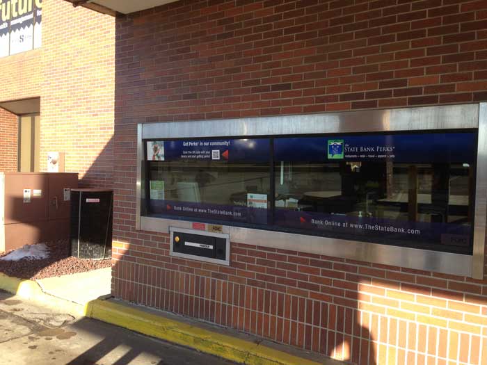 A brick building with a window that says future on it