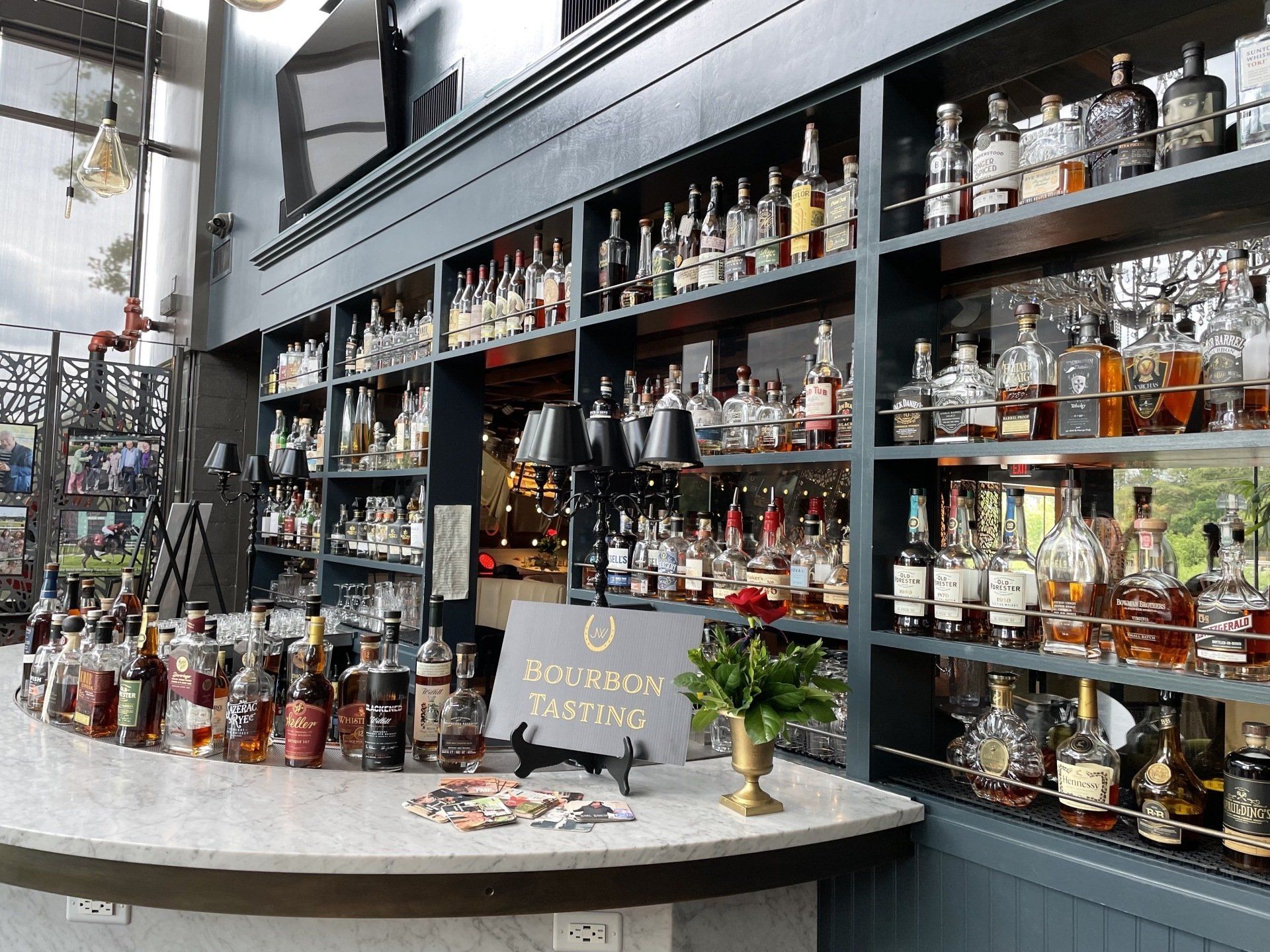 A bar with a lot of bottles of alcohol on shelves