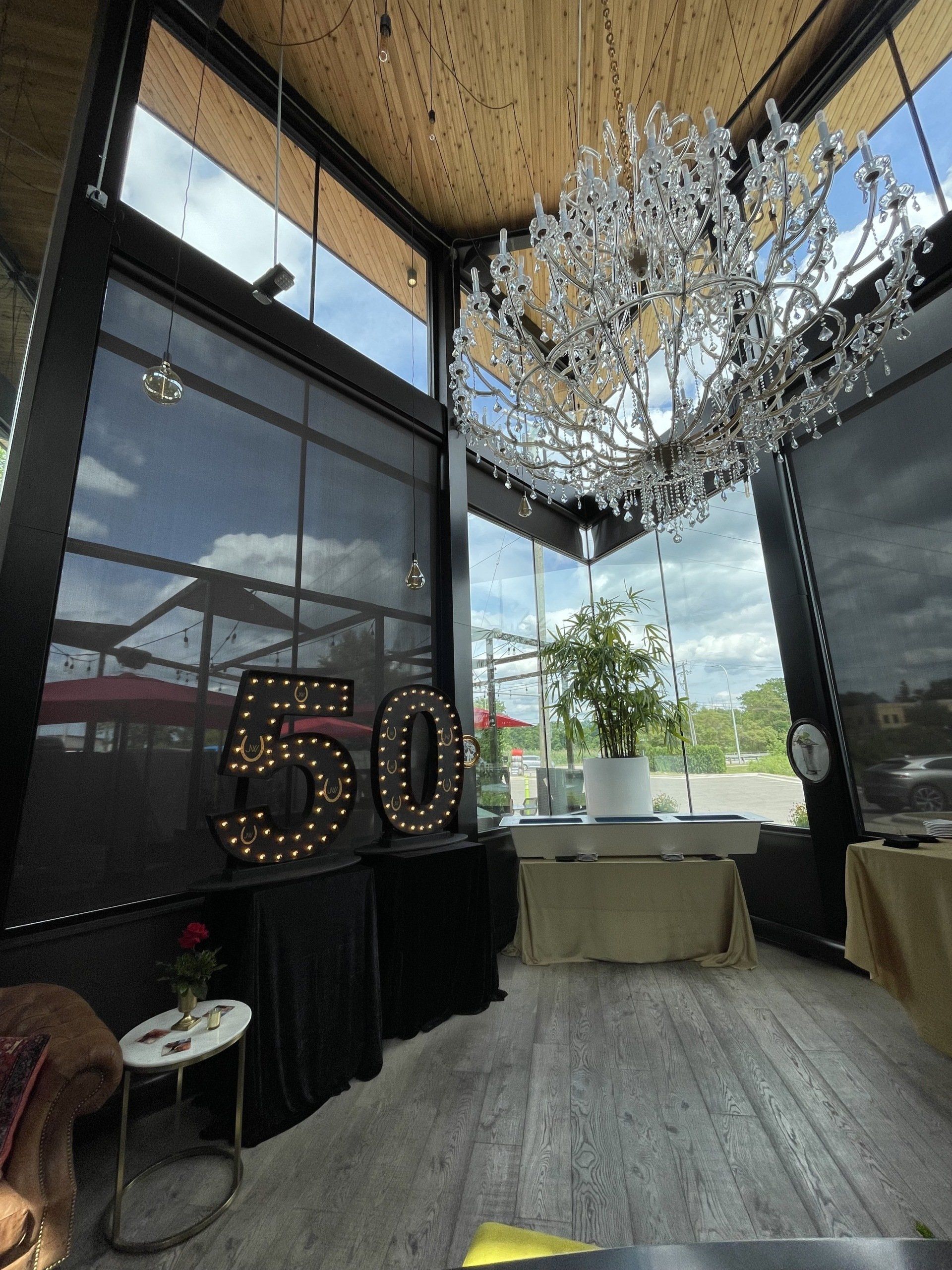 A room with a chandelier and a sign that says 50