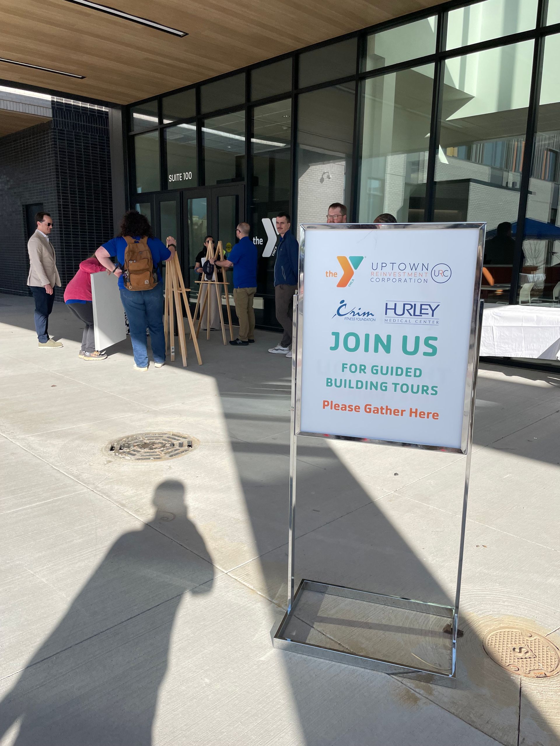 A sign that says join us is outside of a building