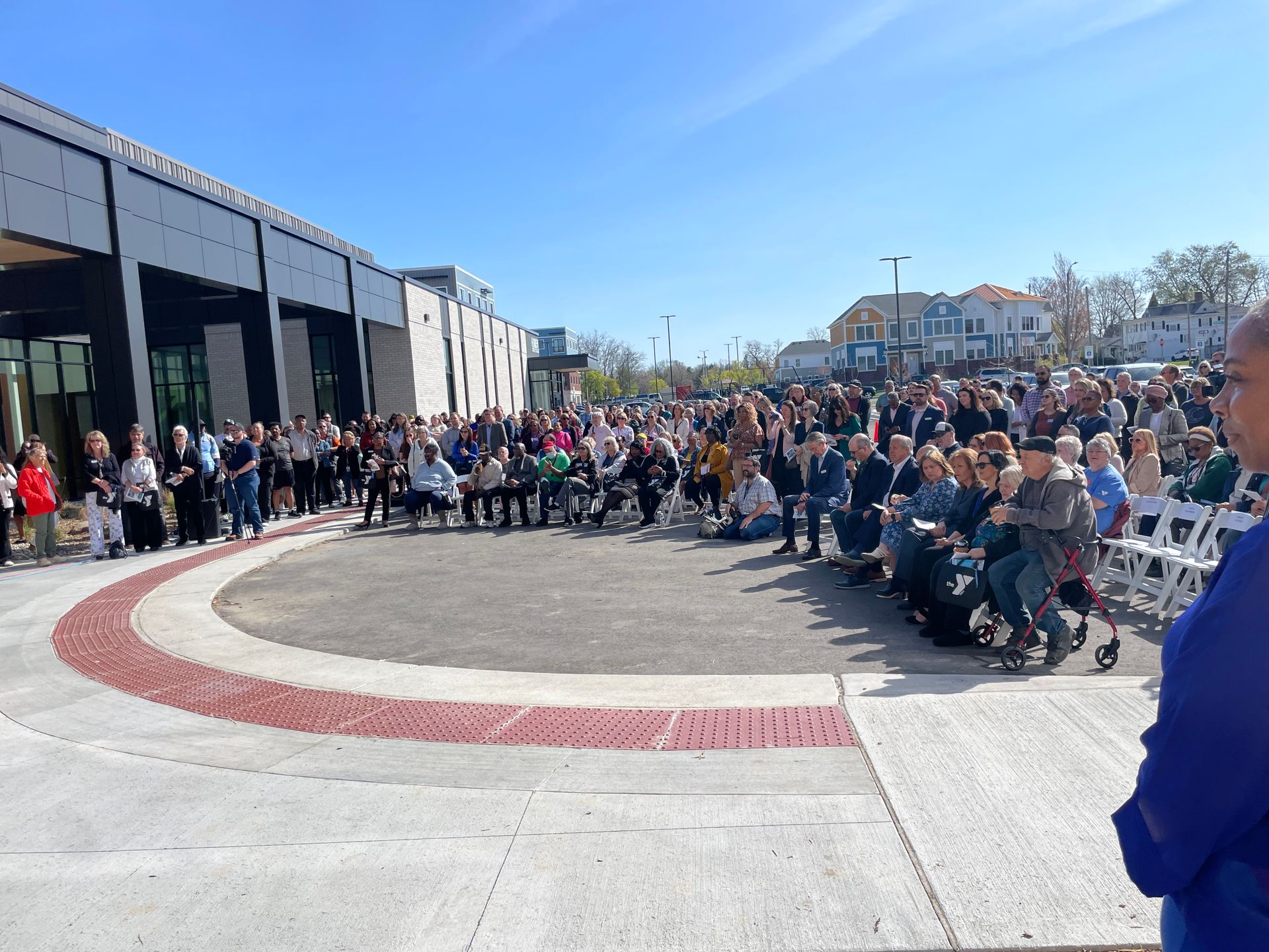 A large group of people are gathered outside of a building