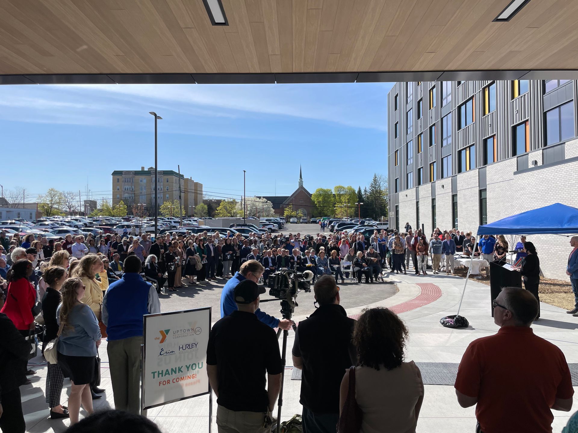 A large group of people are standing in front of a building.