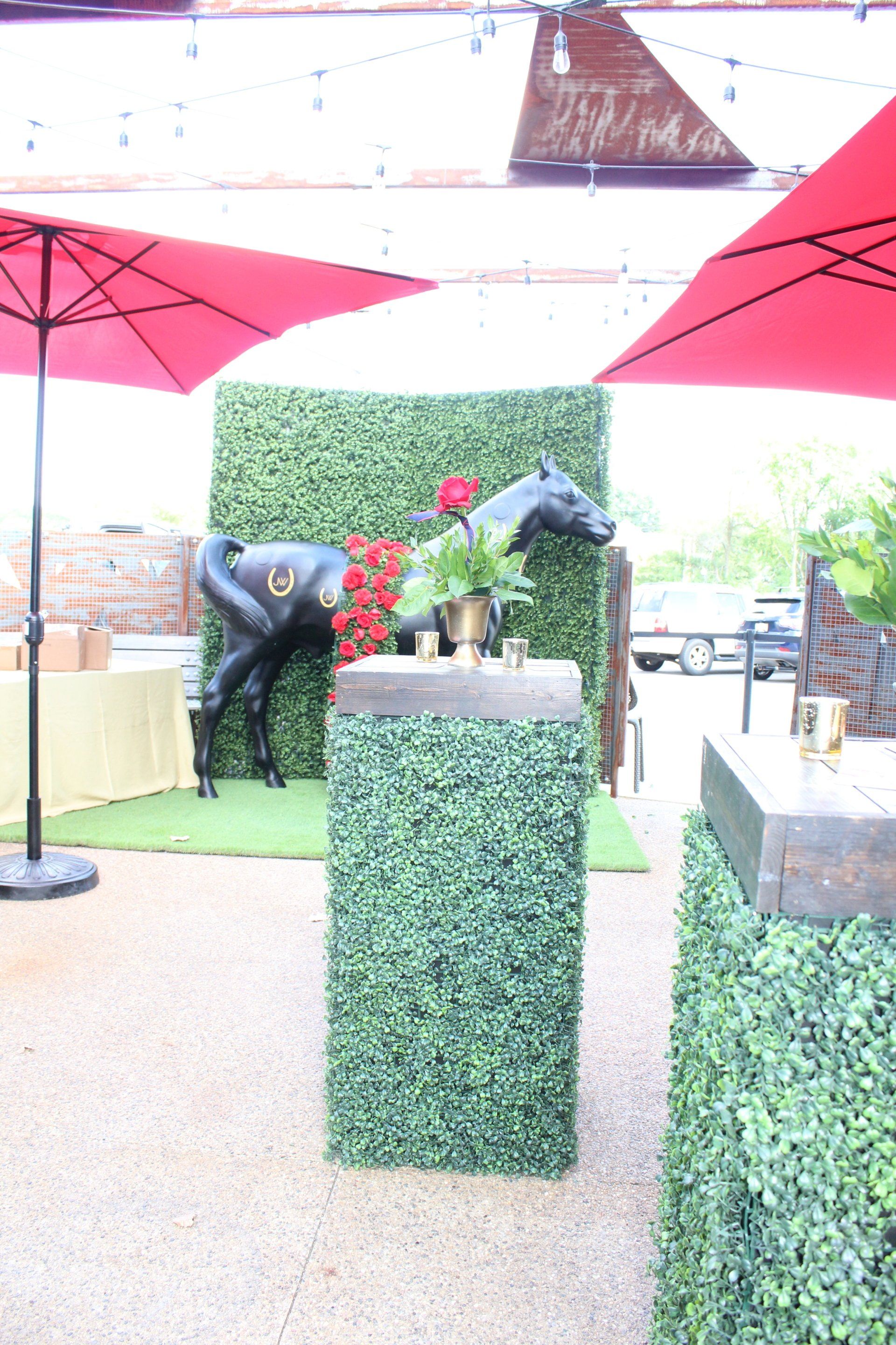 There is a statue of a horse on a pedestal in the background.