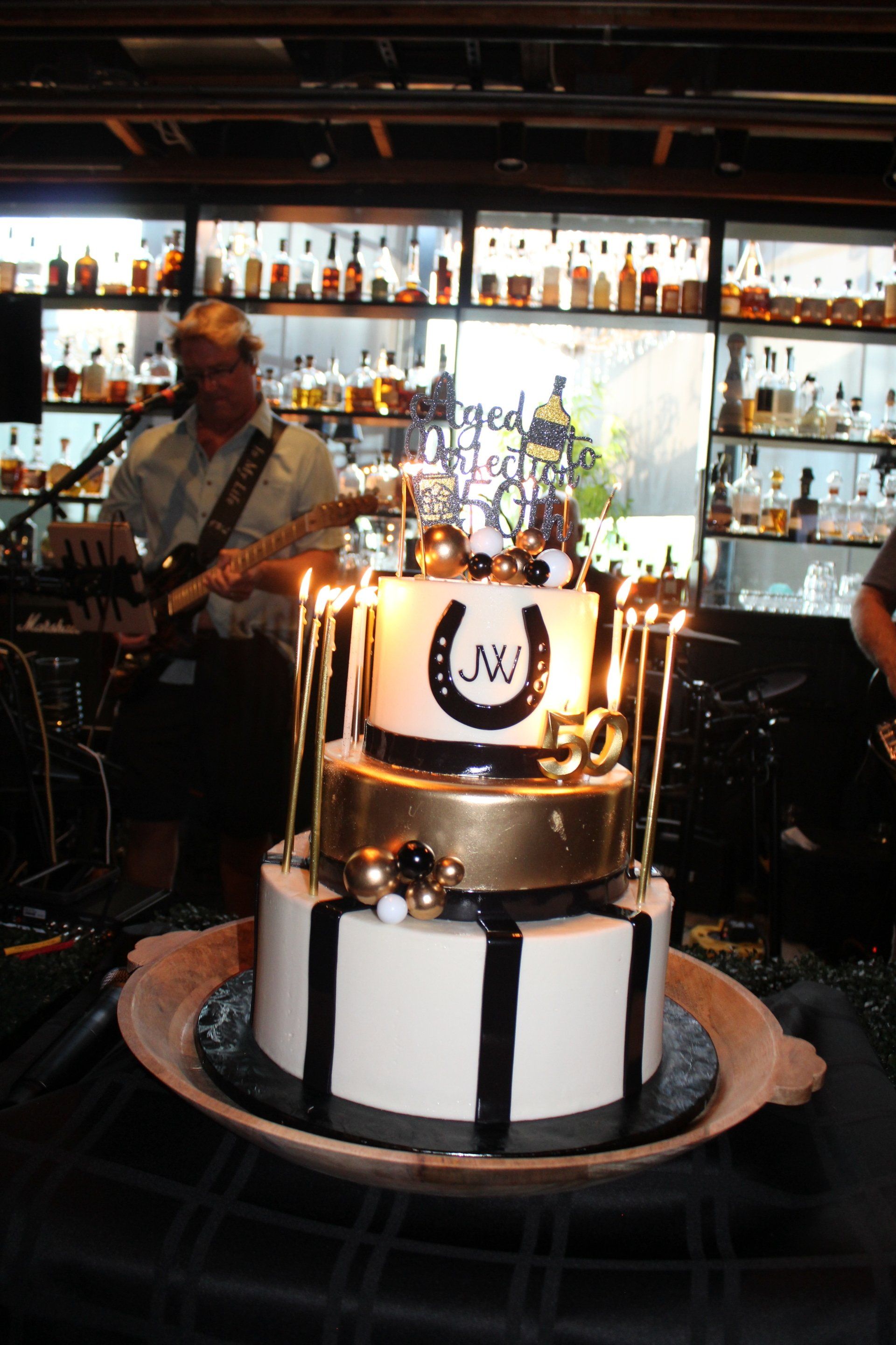 A black and white cake with a horseshoe on it