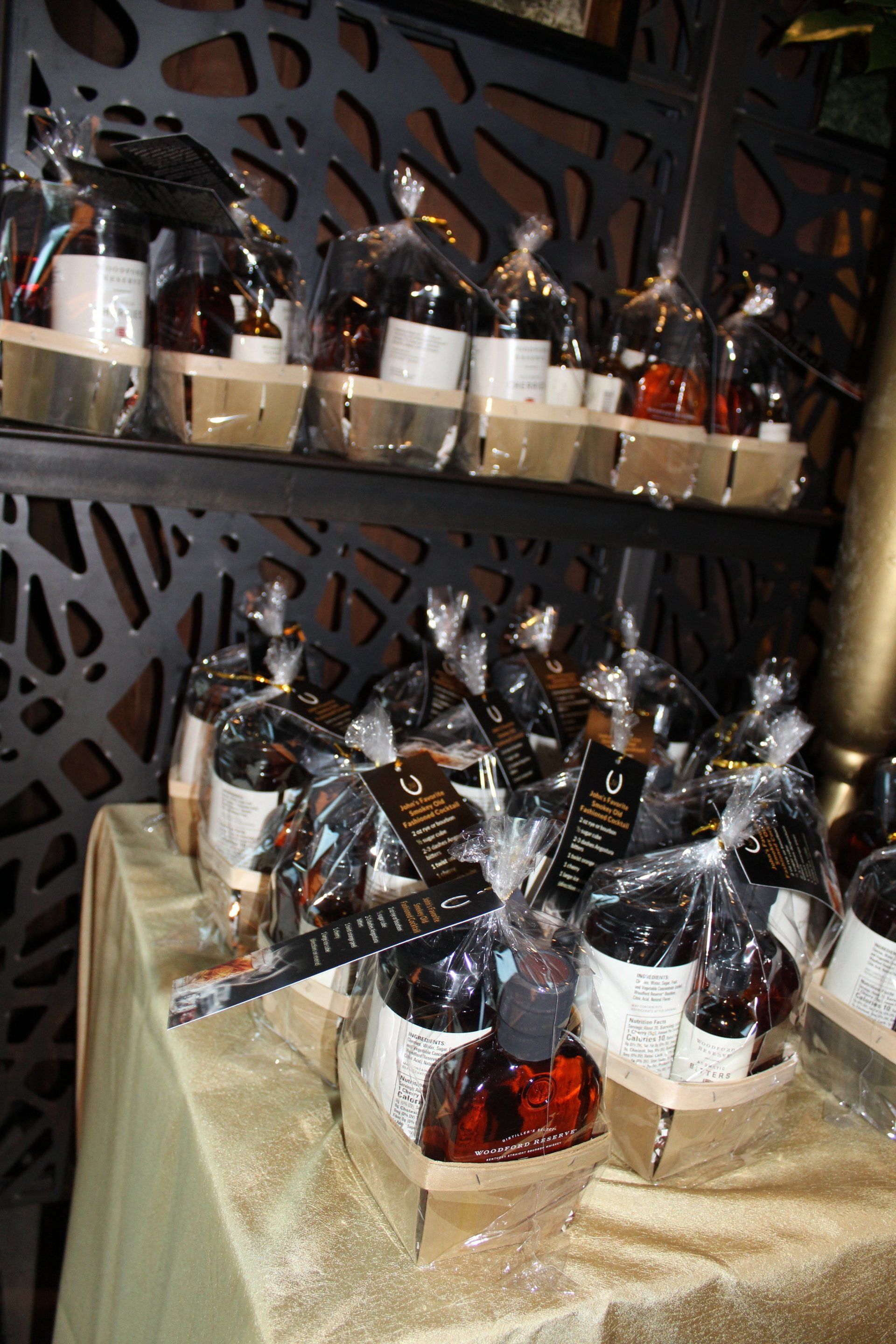 A table topped with bottles of alcohol wrapped in plastic bags.