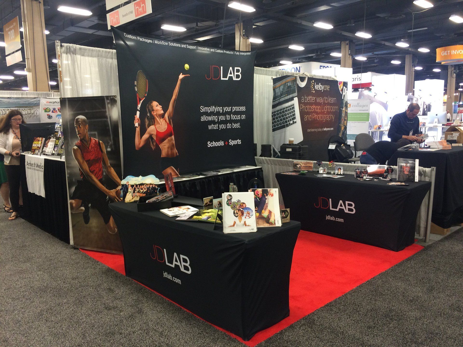 A booth with a woman holding a tennis racquet and the word lab on it