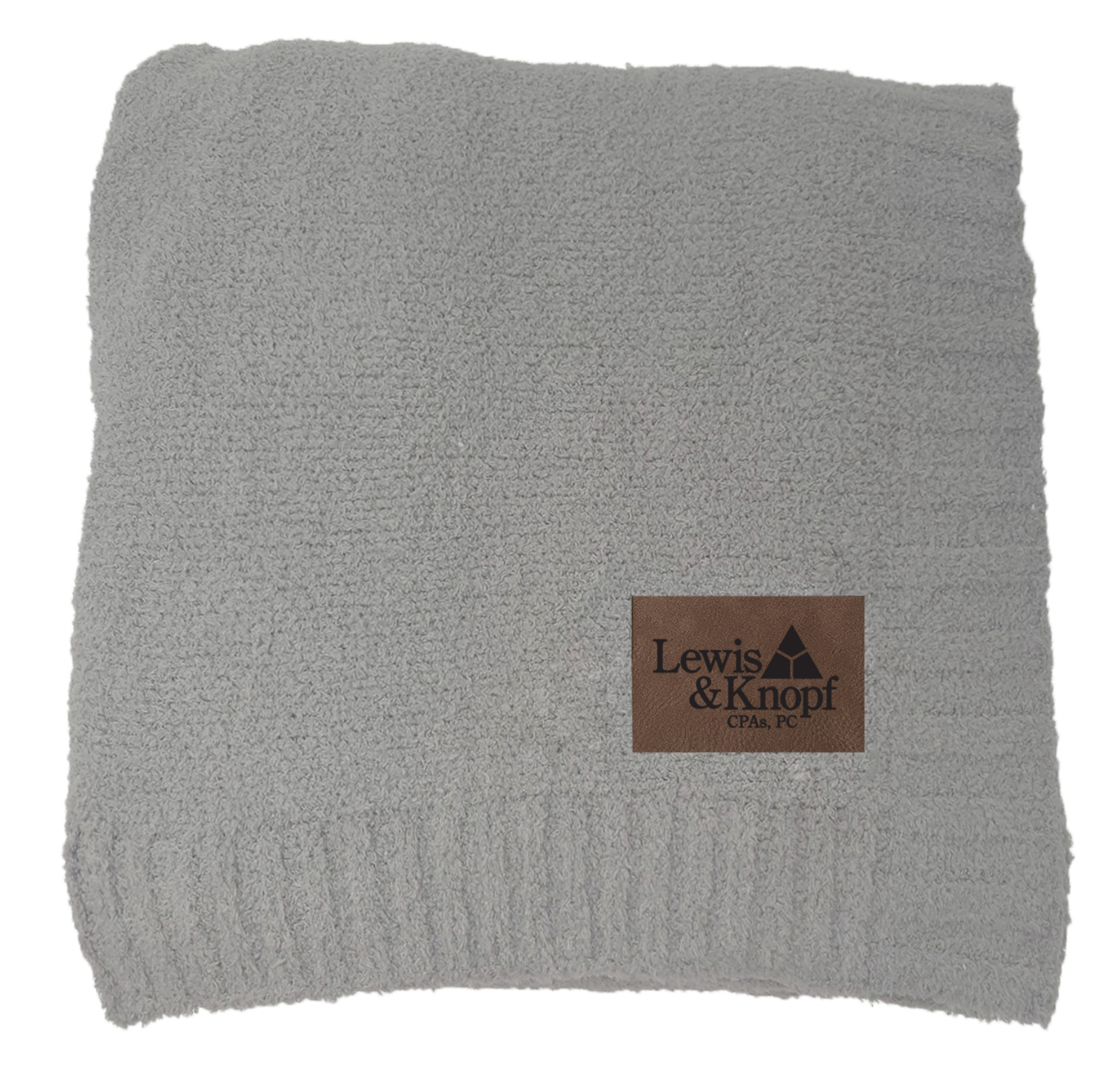 A grey lewis & knopf blanket with a brown label