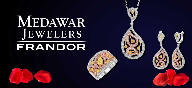 A necklace , earrings , and ring are displayed on a black background.