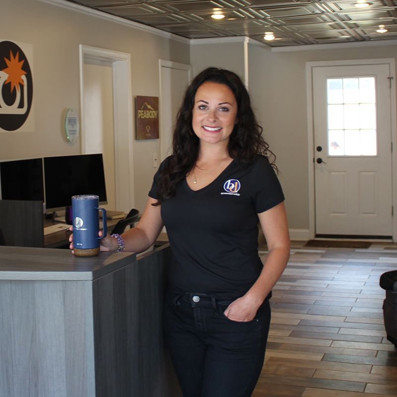 A woman in a black shirt with the letter d on it