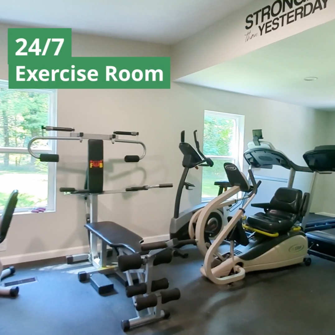 A 24/7 exercise room with lots of exercise equipment