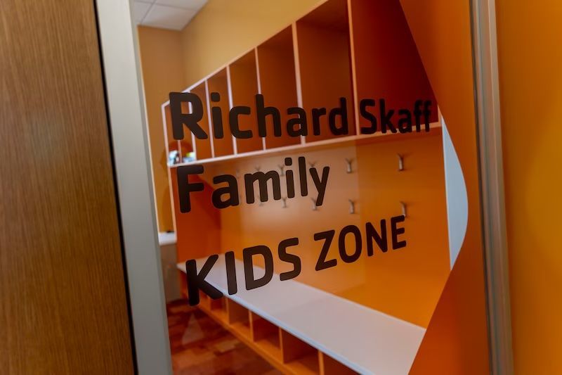 A sign that says richard schaff family kids zone on it
