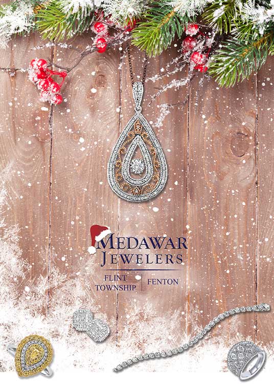 A wooden table with a necklace , ring , and bracelet on it.