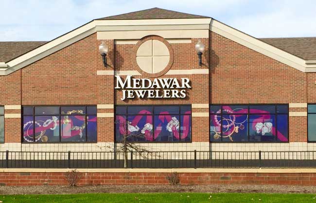 A brick building with a sign that says medawar jewelers