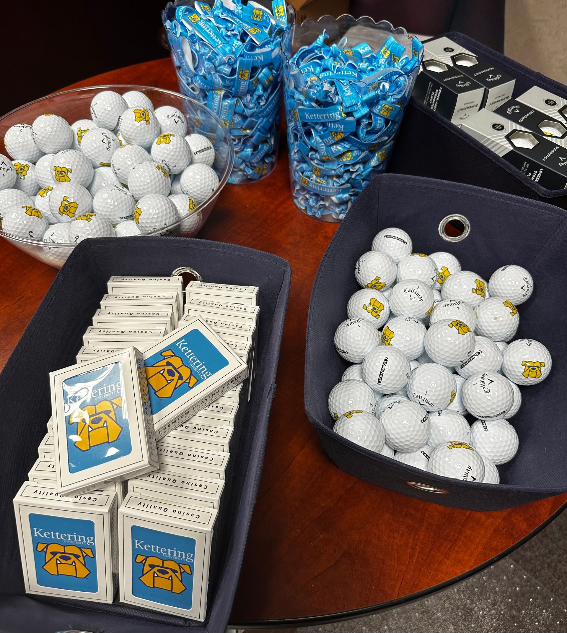A table with a bunch of golf balls and cards on it