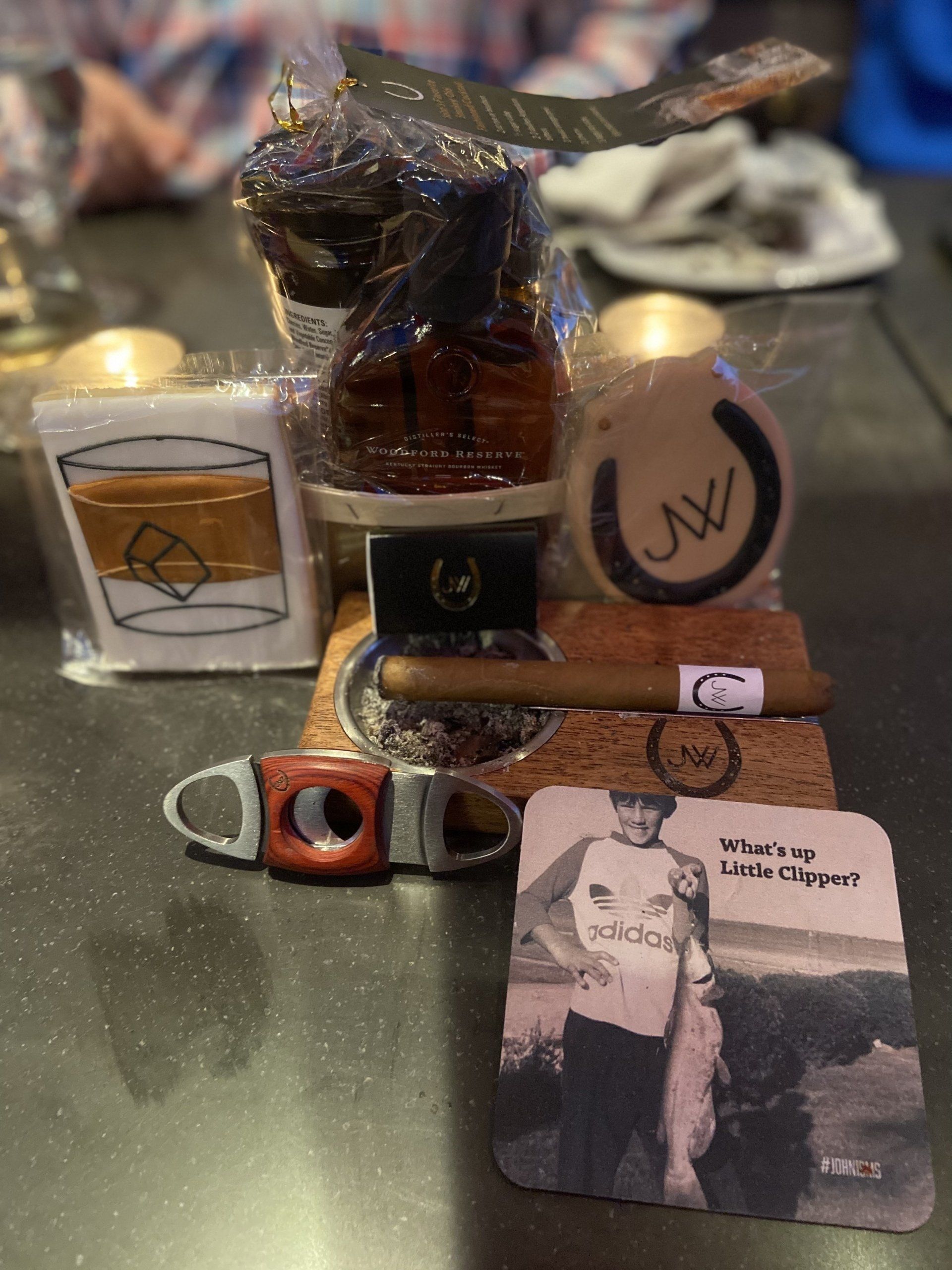 A table with a bunch of items on it including a picture of a man holding a fish