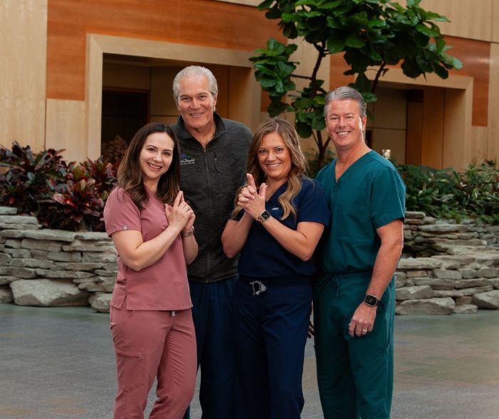 A group of people in scrubs are posing for a picture