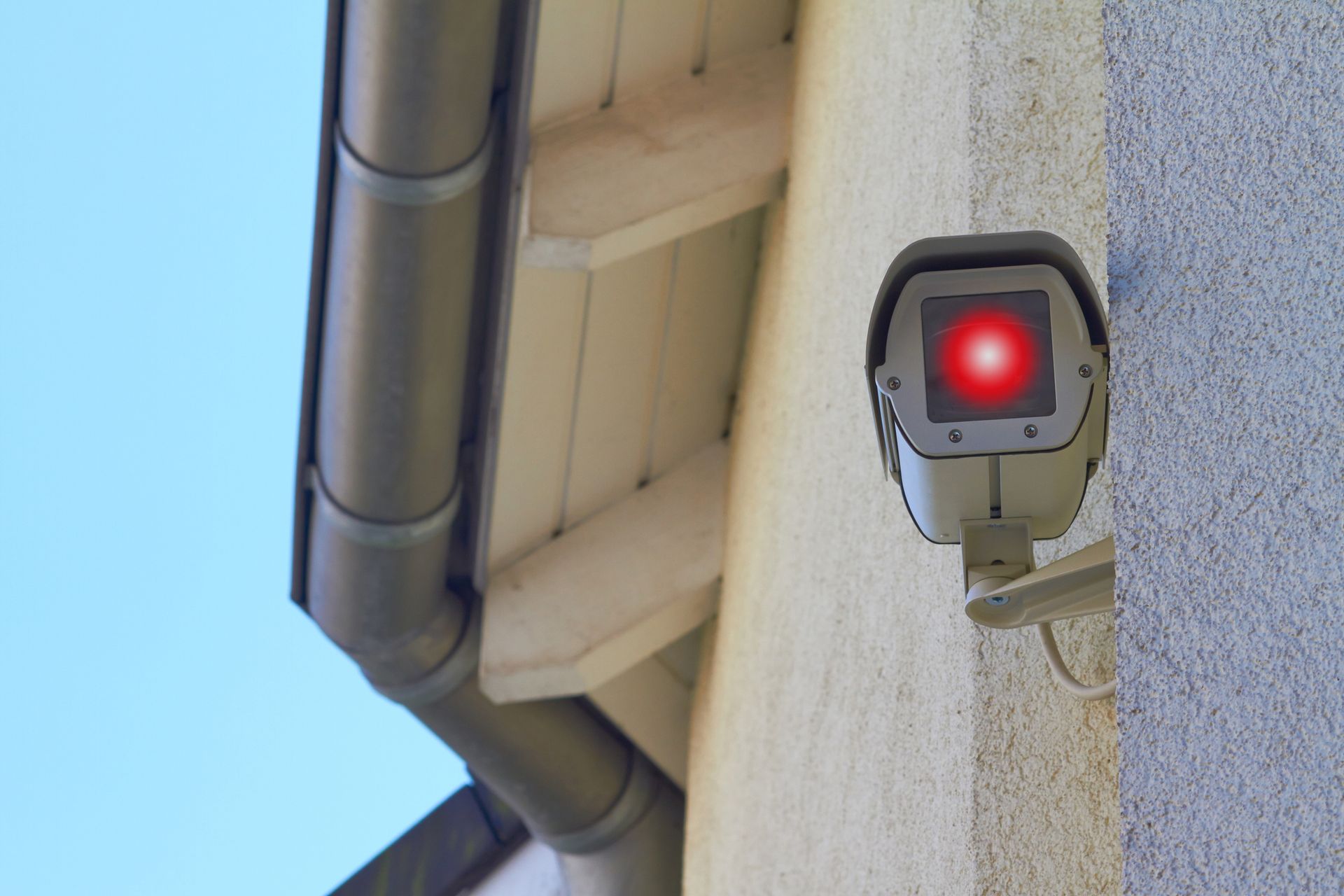 A new security camera is mounted on a wall.