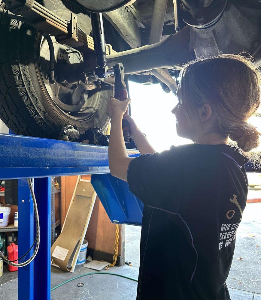 A Woman Wearing A Black Shirt Working In Car — Brake & Clutch Repairs in Albury, NSW