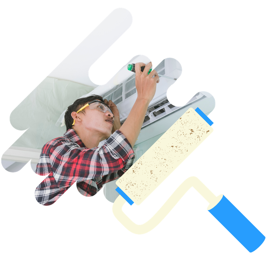 A man in a plaid shirt is working on an air conditioner.